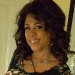 Sheila Abrams wearing a flowered blouse and smiling